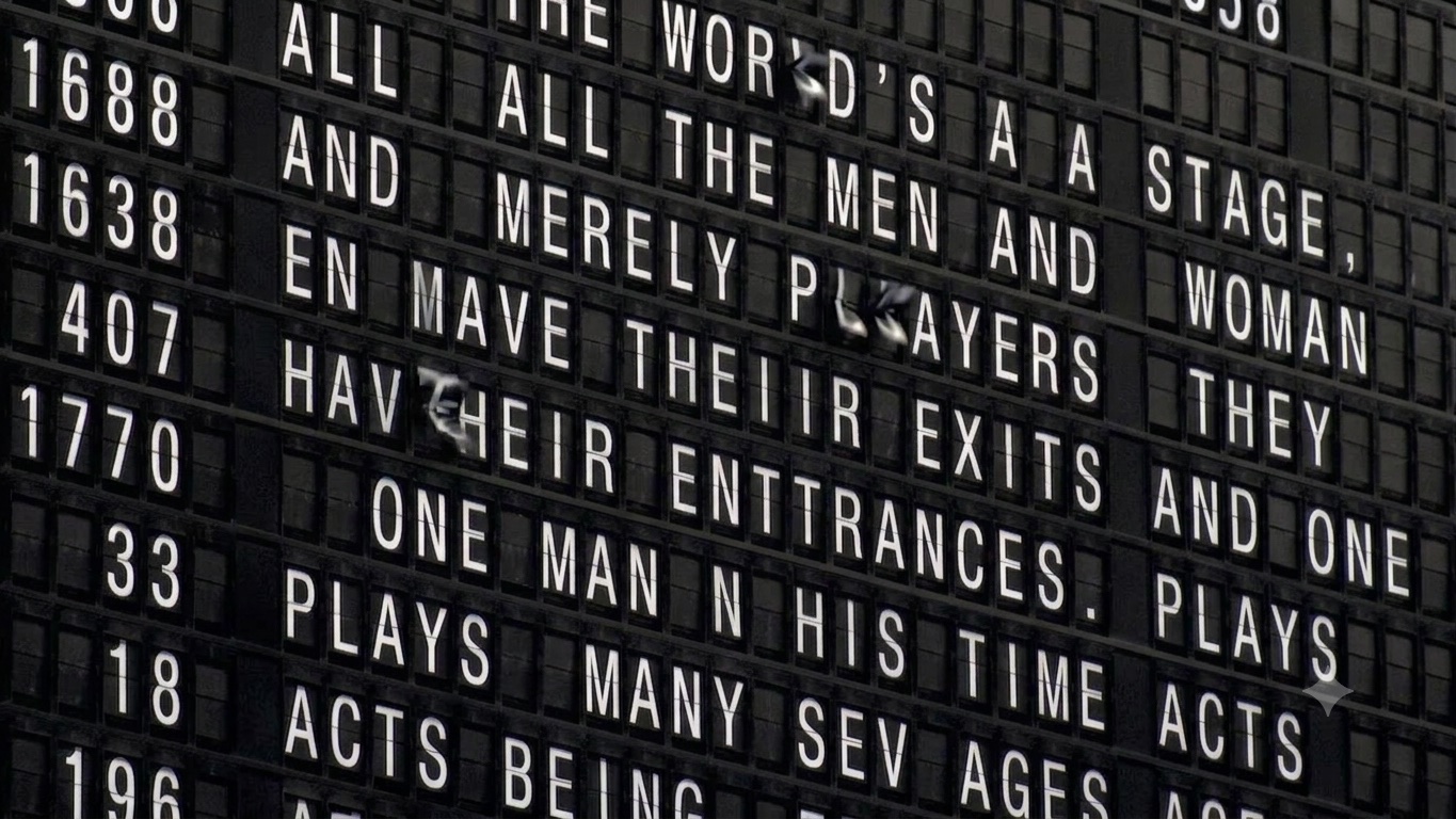 A split-flap departure board misprinting Shakespeare's All the world's a stage